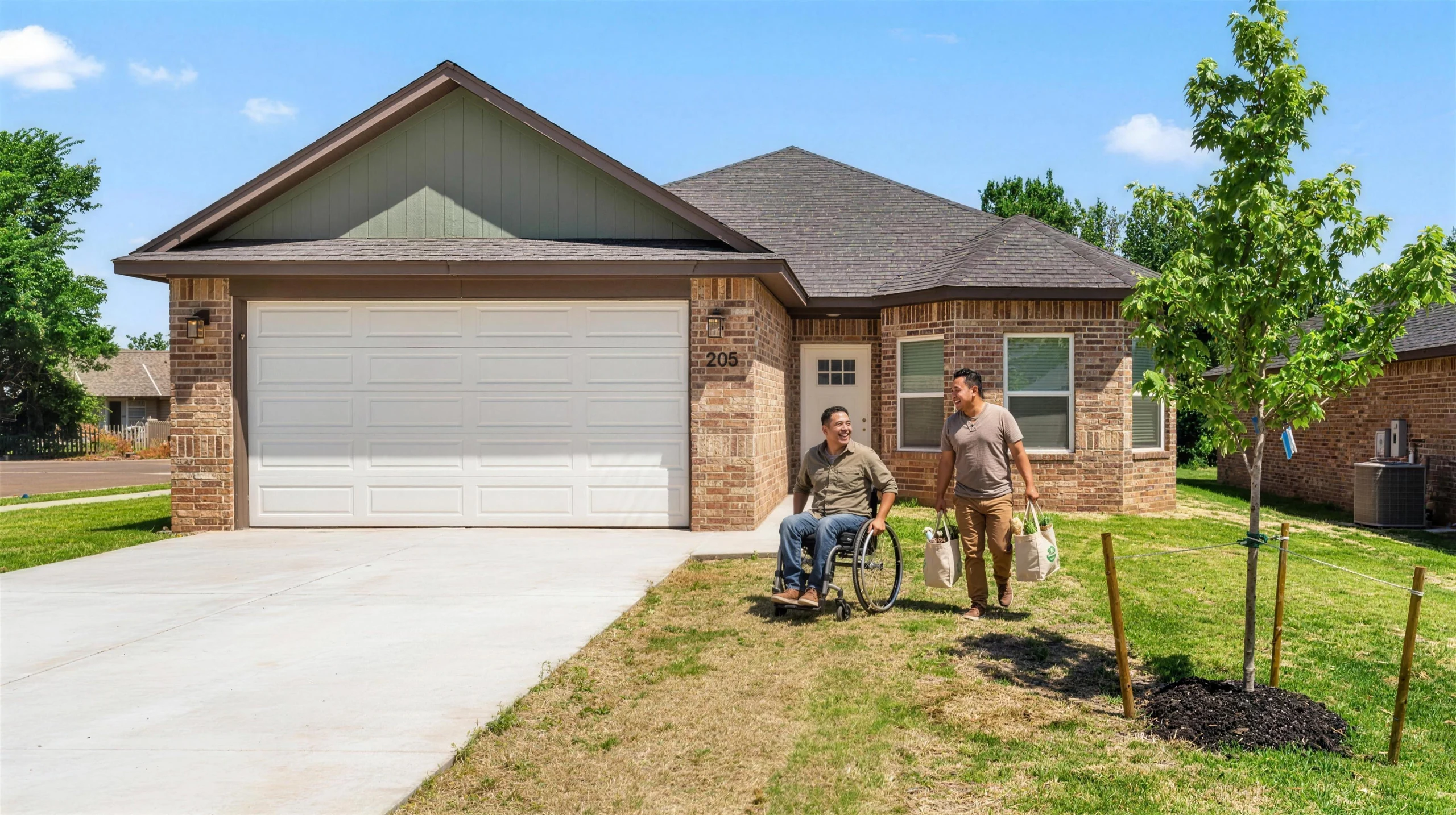 A man using a wheelchair and his partner arriving at an accessible Meadow Hills home